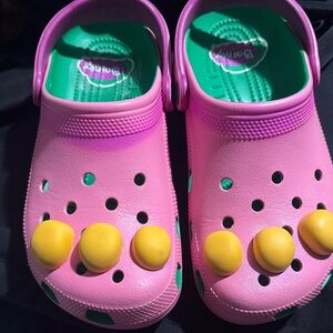 Pink and Yellow Kids Crocs Barney edition.